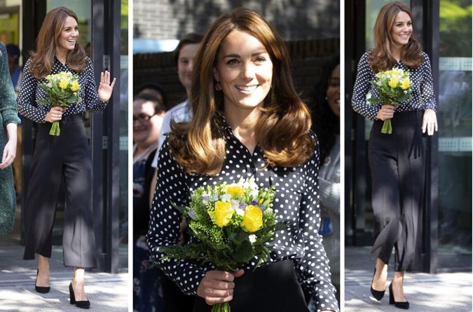 Kate wore navy polka dot blouse with high-waisted wide-leg black trousers.