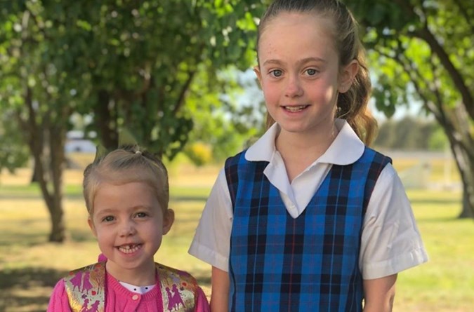 Scout with older sister Sailor, a dead-ringer for father Grant. Image: Instagram