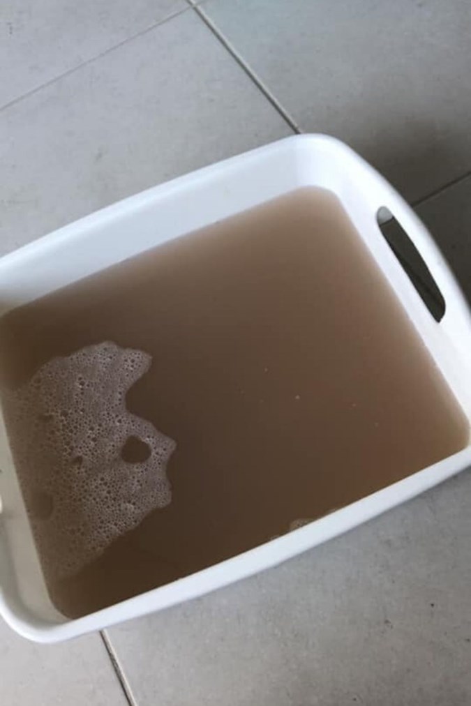 Another Facebook user reveals the murky water that was flushed from her washing machine after doing the dishwashing tablet hack. Credit: Mums Who Clean/Facebook