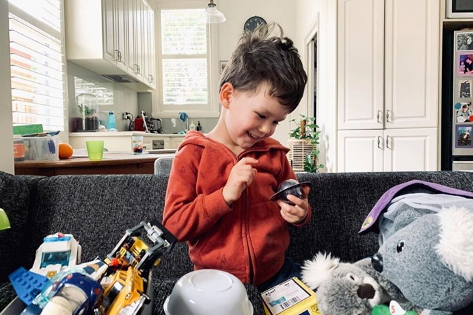 Dana's son Jasper is surrounded with toys including what looks like a purple Wiggle dress-up costume. Image: Dana Stephensen/Instagram