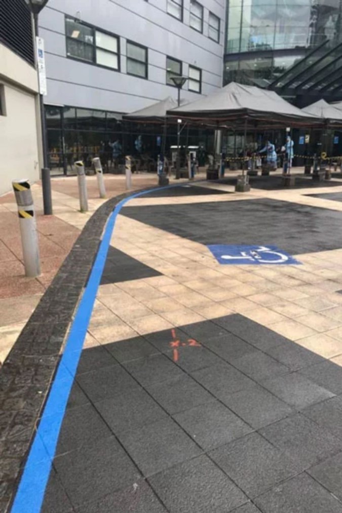 THE PATH TO THE COVID-19 CLINIC IS MARKED BY A BLUE LINE