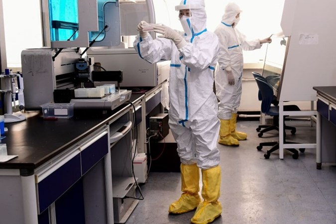 Laboratory technicians work on testing samples at a laboratory in Shenyang, China. Image: Getty.