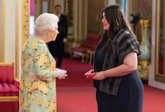 Caitlin meeting Her Majesty The Queen at Buckingham Palace