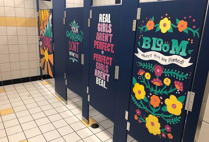 Middle school teachers painted inspiring messages on bathroom doors