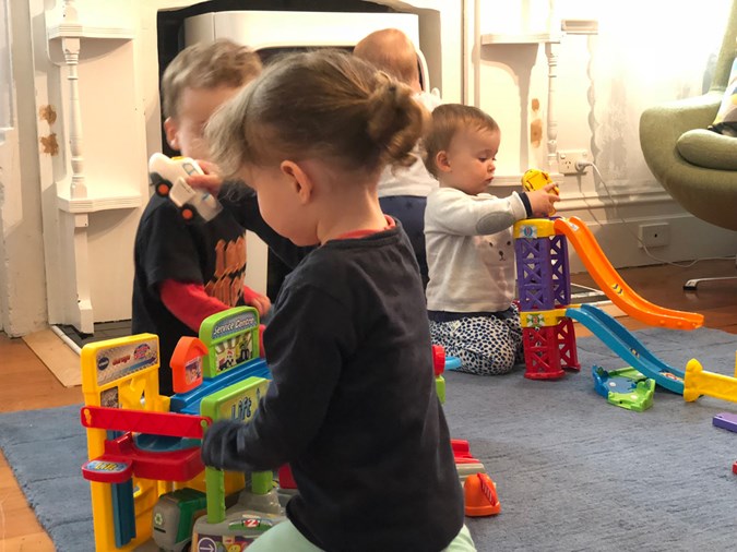 From Left: Ezra and Alba role play  with their trucks and cars, while Cara plays with the ramps and her little friend behind her, Louis, wanders around the pit!